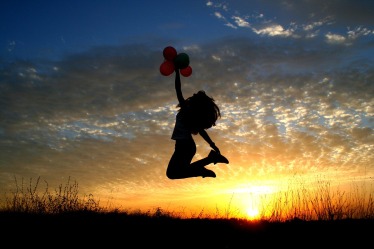 Girl With Balloons Jumping